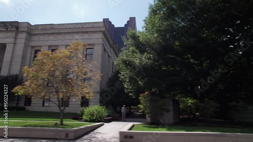 Ohio Statehouse and capitol building in city center of Columbus, OH as car drives by, with historic and political significance with architecture, legislation, statues, and governor of Midwest State photo