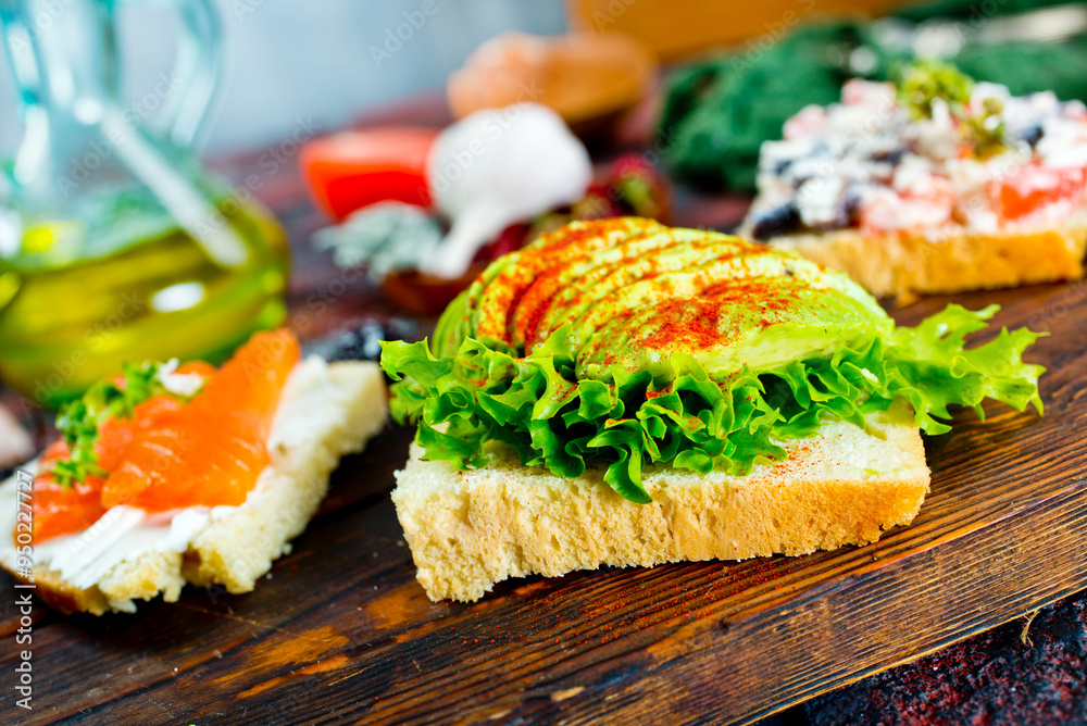 Open sandwiches with salted salmon, guacamole avocado and microgreens.