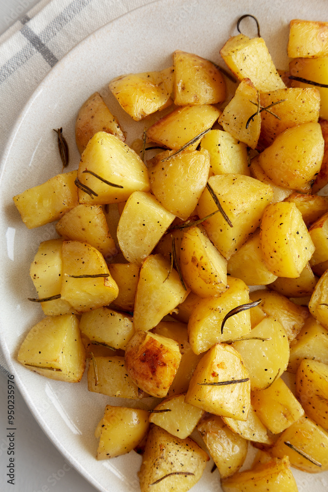 Homemade Oven Roasted Potatoes on a Plate, top view. Flat lay, overhead, from above. Homemade Oven Roasted Potatoes on a Plate, top view. Flat lay, overhead, from above.