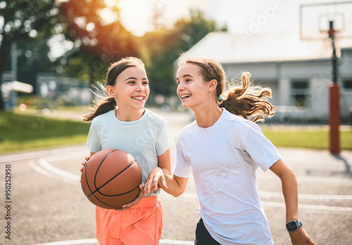 two childs girls in sportswear playing basketball game