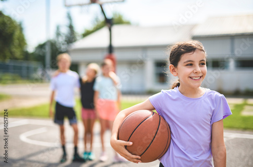 Childs girls Team in sportswear playing basketball game