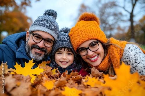 Autumn family portrait in a park, captured in a photo where a family poses among the fallen leaves in a park, with everyone dressed in cozy autumn attire and the vibrant colors of the season photo