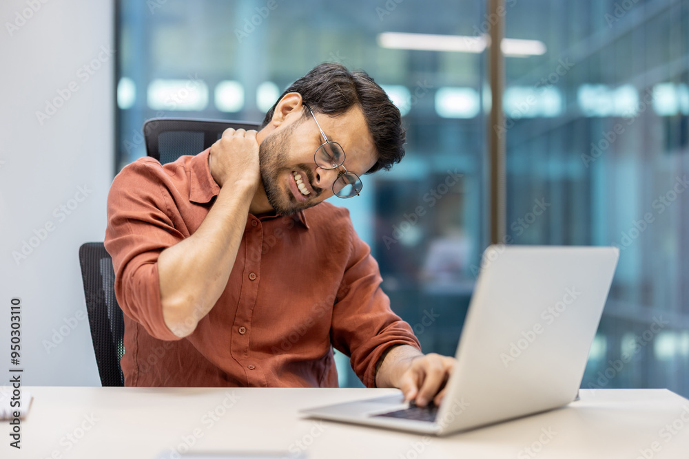 Office employee feeling neck pain while working on laptop. Professional in modern office showing signs of stress and discomfort, highlighting ergonomic issues common in workplace environments. Office employee feeling neck pain while working on laptop. Professional in modern office showing signs of stress and discomfort, highlighting ergonomic issues common in workplace environments.