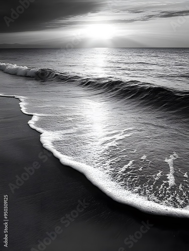 Black-and-white image of a deserted beach at dawn, with gentle waves and the interplay of light and shadow creating a peaceful, timeless scene