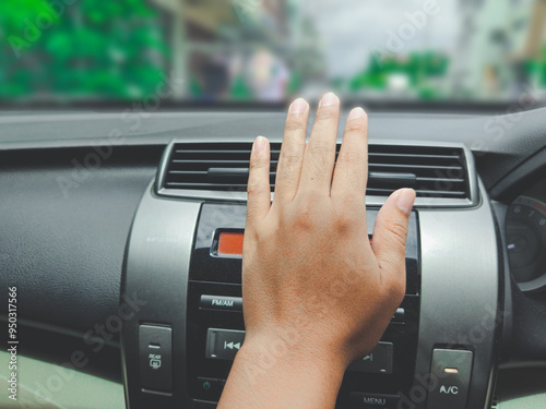 hand checking air vent inside the car, front view