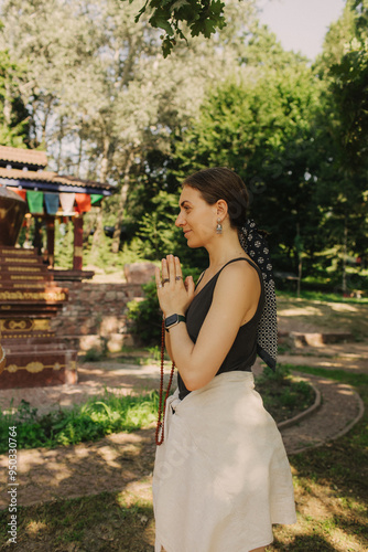 Woman practicing yoga and meditation in park, relaxed with closed eyes. Mindful meditation concept. Wellbeing. No focus blurred and noise effect. Part of the series