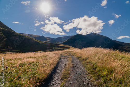 Panoramic landscape with a path in the mountains, on a sunny day. In Pirineos, Huesca (Spain).