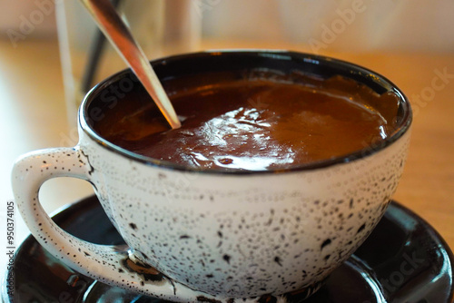 Hot chocolate cocoa mug. closeup hot chocolate in white mug with spoon