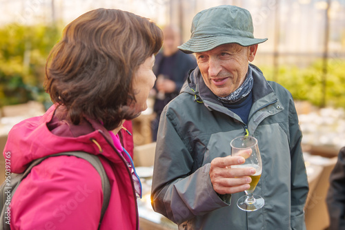 Man and woman chatting in a greenhouse at Fridheimar photo