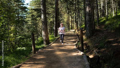 Active middle-aged woman jogs runs