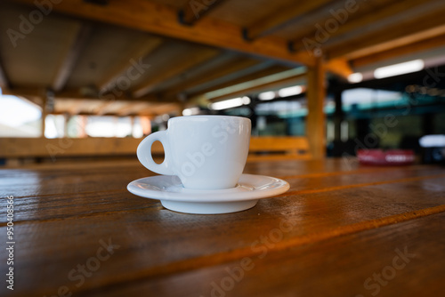 Small white coffee cup on a saucer. photo