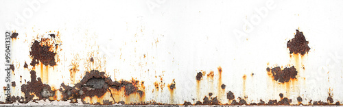Rusty metal background with streaks of rust. Rust on white background. The metal surface rusted spots. Rusty corrosion. Panorama.