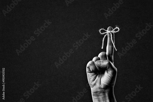 Canvas Print Rope Bow on Finger Pointing Sign in Black and White on Textured Paper Background