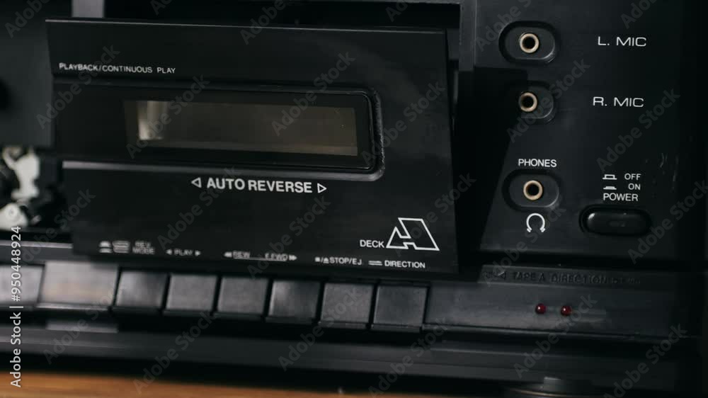 Retro radio tape recorder, audio cassette close-up. Listening to music, old radio boom box player, macro of vintage music listening. Retro radio tape recorder, audio cassette close-up. Listening to music, old radio boom box player, macro of vintage music listening.