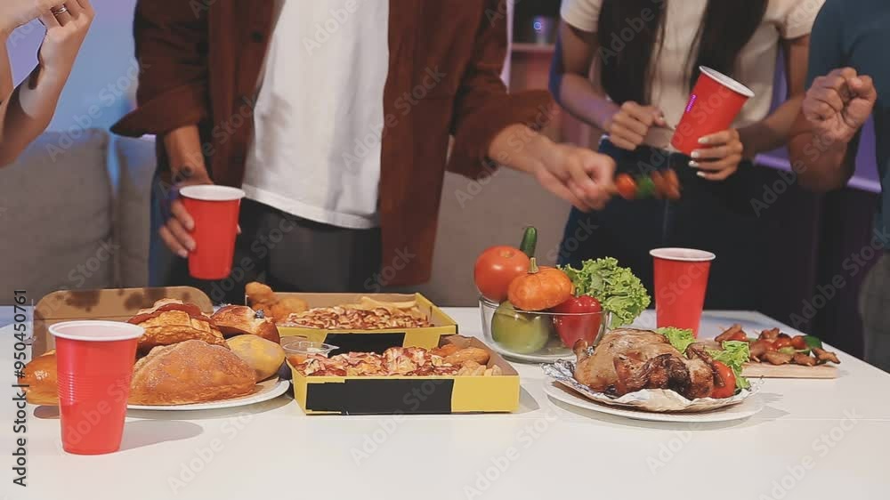 group of cheerful friends eating pizza at house party style.