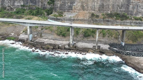 Aerial view of Sea cliff Bridge at the edge of Pacific coast, Wollongong, Illawarra, New South Wales, Australia. The 665 metre long Sea Cliff Bridge is a highlight along the Grand Pacific Drive photo