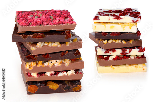 The image shows stacks of gourmet chocolate bars in various flavors, including dark, milk, and white chocolate. Each bar is topped with dried and candied fruits, creating a colorful and indulgent dess photo