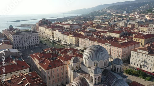 The aerial view of Saint Spyridon Church and Piazza della Libertà in Trieste, Italy. Historic city landmarks captured from above. Trieste, Italy. photo