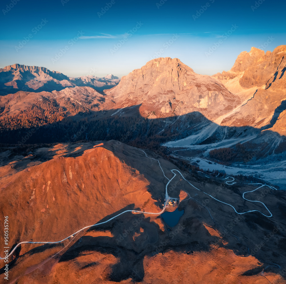 Obraz premium Amazing autumn scene of Rolle pass. Stunning morning view from flying drone of Dolomite Alps, Italy, Europe. Beauty of nature concept background.