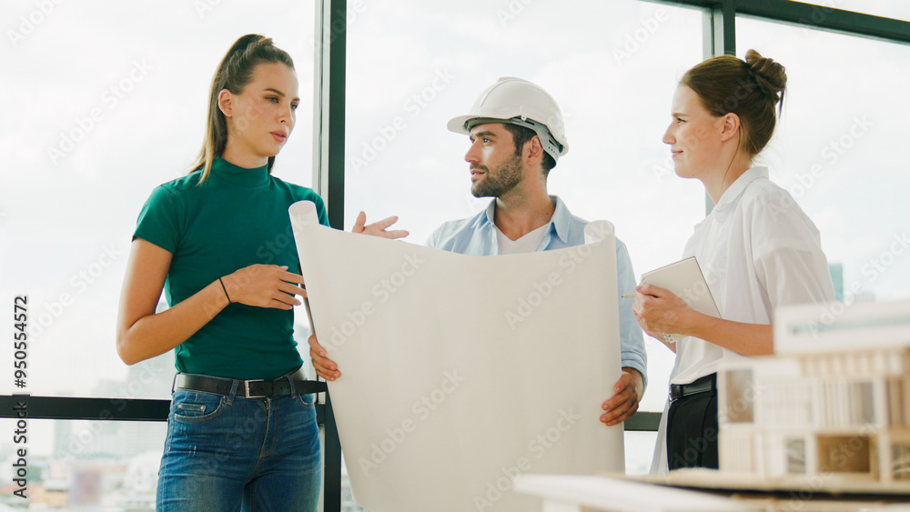 Professional architect engineer team talking, sharing, brainstorming about design while manager hold at project plan. Young architect holding plan while manager listen and point at plan. Tracery Professional architect engineer team talking, sharing, brainstorming about design while manager hold at project plan. Young architect holding plan while manager listen and point at plan. Tracery