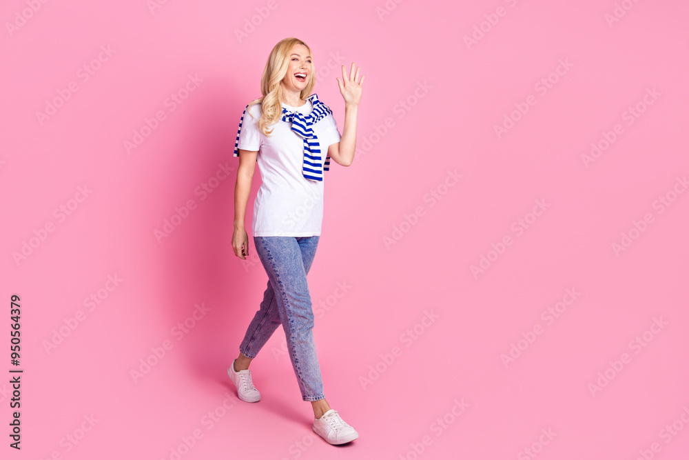 Full body photo of attractive young woman walking wave hand hi dressed stylish white clothes isolated on pink color background Full body photo of attractive young woman walking wave hand hi dressed stylish white clothes isolated on pink color background