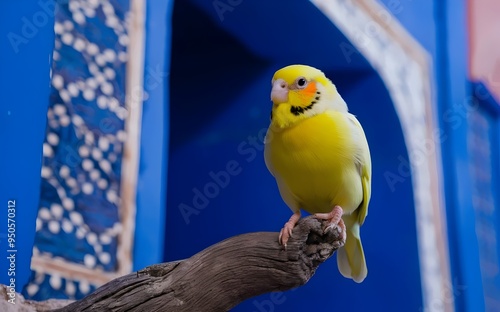 A yellow canary perched on a wooden branch against a blue background 
