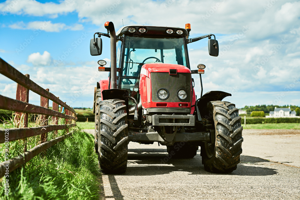 Obraz premium Outdoor, farm and agriculture with tractor for tiling, plowing and cultivation of soil for crop growth. Blue sky, nature and machine truck in countryside for harvesting, planting and sowing of seeds