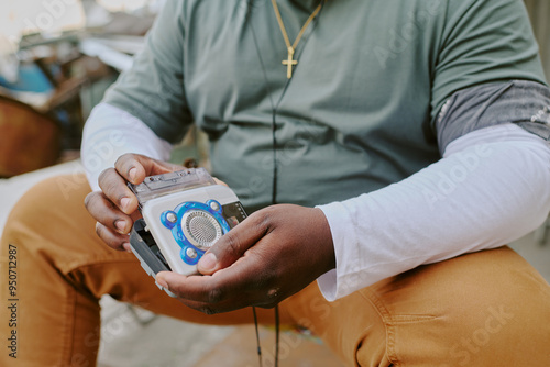 Unrecognizable male hands holding old fashioned tape recorder photo