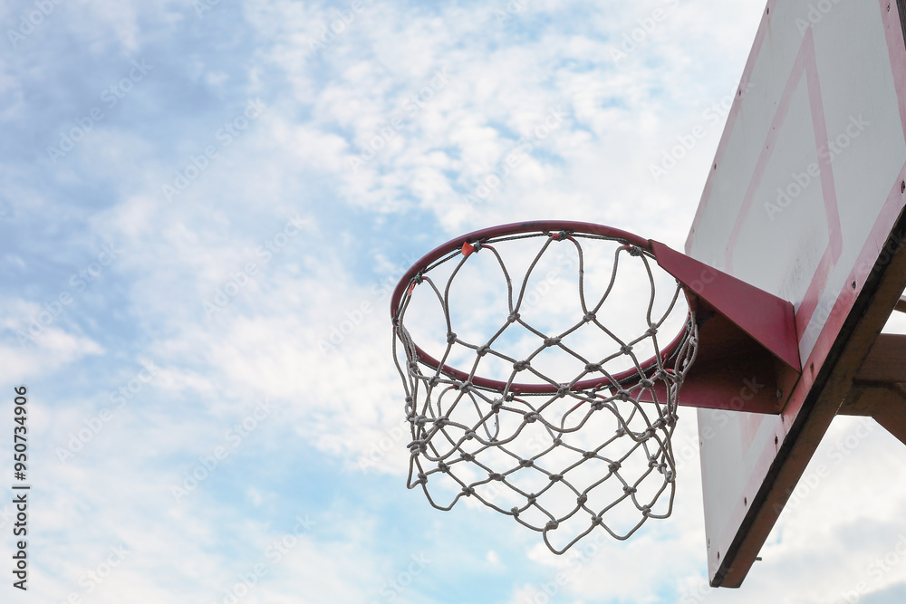 Basketball backboard with a basket on a sports ground.