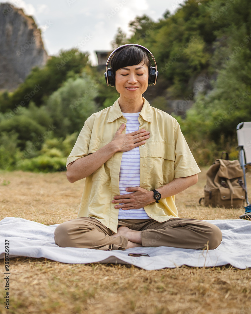 Fototapeta premium Japanese woman practice guided meditation manifestation in front tent