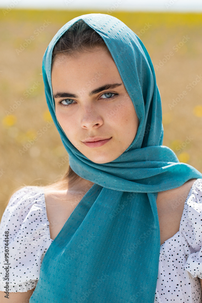 Close up portrait of a young woman in a traditional patterned headscarf Close up portrait of a young woman in a traditional patterned headscarf