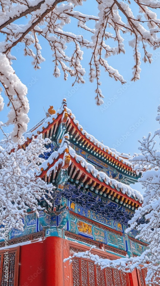 Snow-covered ancient Chinese architecture with intricate design under winter sky