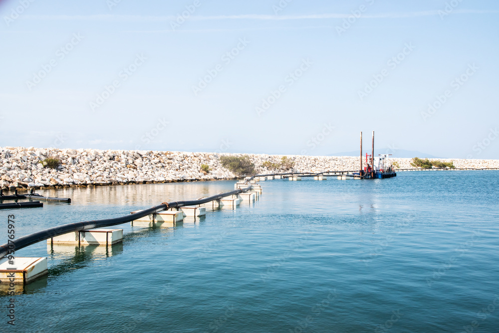 Fototapeta premium Dredger ship in Mediterranean port on sunny summer day