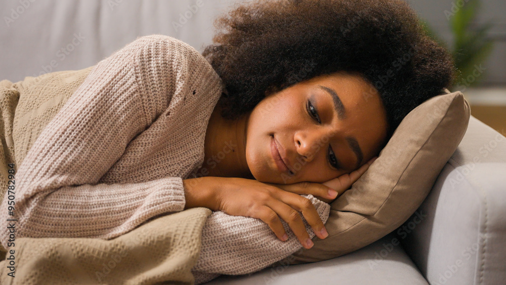 Close-up of young African American woman relaxing sleeping daytime covered with blanket lying on pillow couch in living room cute girl ethnic female peaceful rest sleep nap on comfortable sofa at home Close-up of young African American woman relaxing sleeping daytime covered with blanket lying on pillow couch in living room cute girl ethnic female peaceful rest sleep nap on comfortable sofa at home