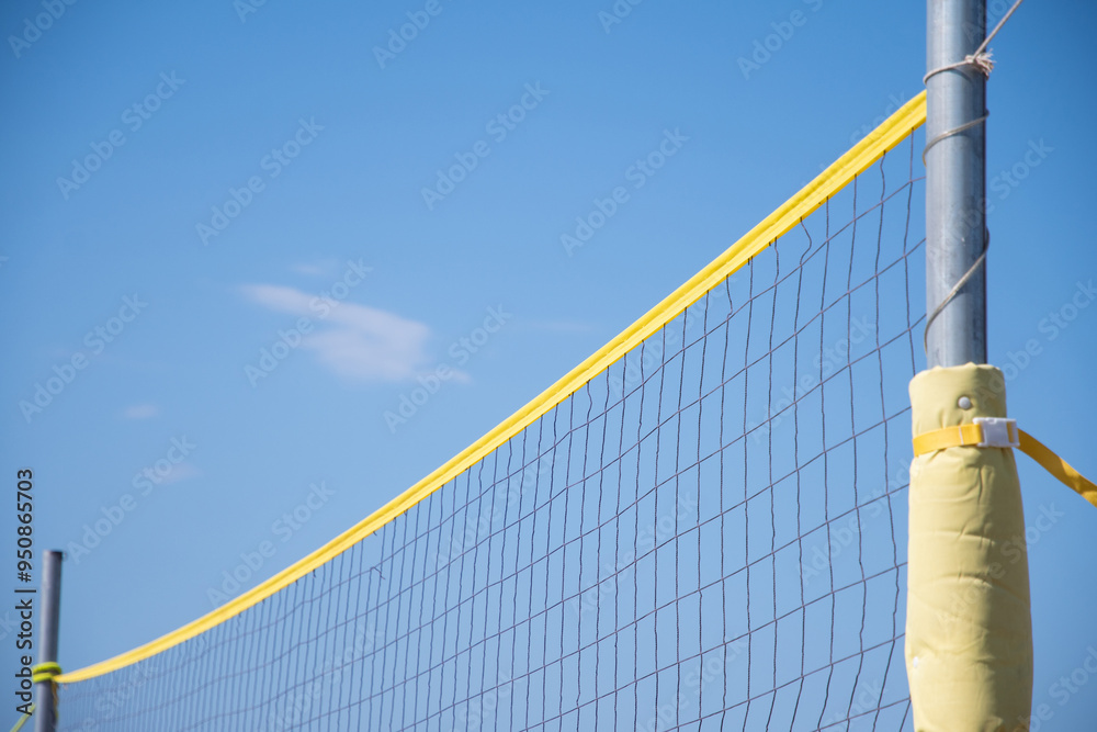 the ball flies through the net against the background of a clear blue sky, beach volleyball in the sea or ocean in summer, ball matches and active activities, copy space the ball flies through the net against the background of a clear blue sky, beach volleyball in the sea or ocean in summer, ball matches and active activities, copy space