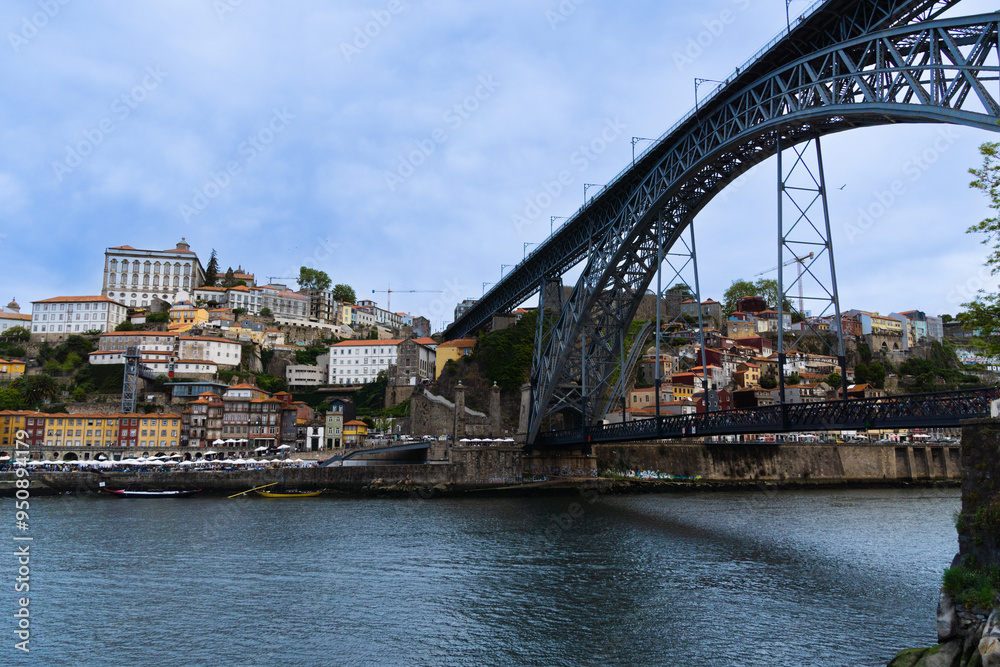 Fototapeta premium View of Porto city and Douro river and Dom Luis bridge. Porto, Vila Nova de Gaia, Portugal. Cityscape along the river