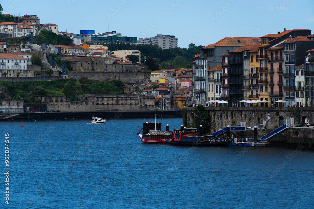 Fototapeta premium View of Porto city and Douro river and Dom Luis bridge. Porto, Vila Nova de Gaia, Portugal. Cityscape along the river