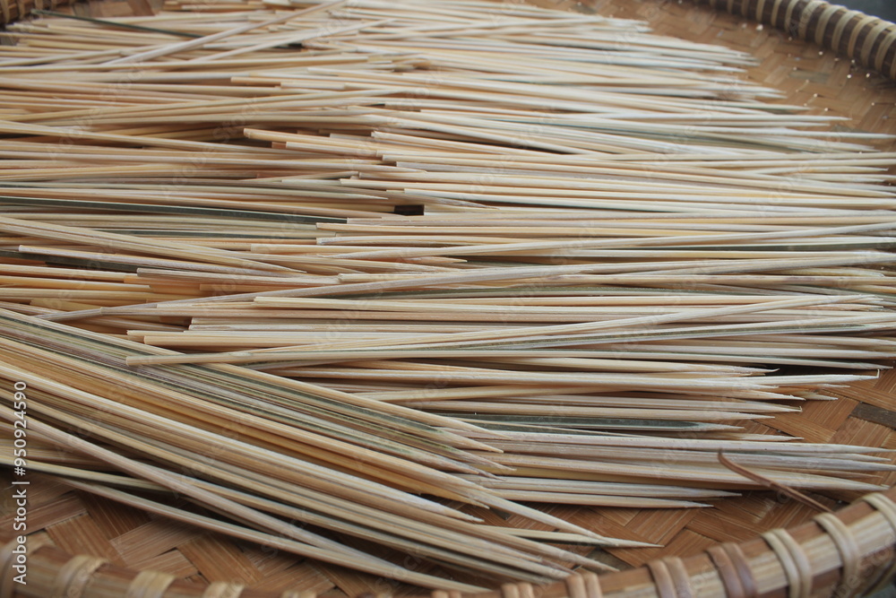 Stacks of skewers in woven bamboo called tampah

