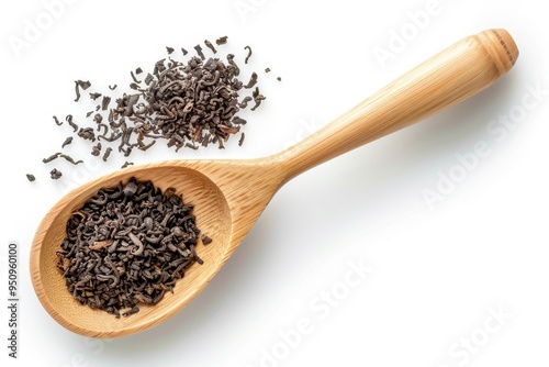 Black tea in wooden spoon on white background View from above photo