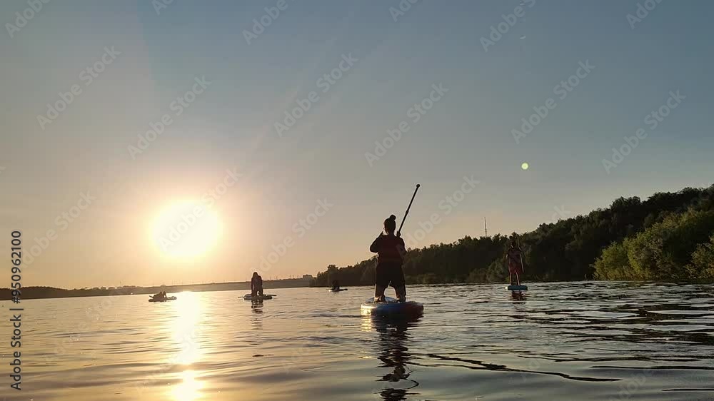 Womans silhouettes on Water, Sup board, paddle boarding in slow motion Womans silhouettes on Water, Sup board, paddle boarding in slow motion