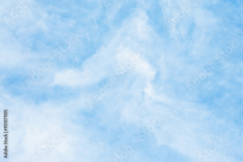 Fototapeta Naklejka Na Ścianę i Meble -  Milky sky with clouds resembling mist. Soft heaven texture of the sky. Hazy, foglike clouds providing a dreamy, heavenly atmosphere. Blue sky background. Bright clodus pattern.