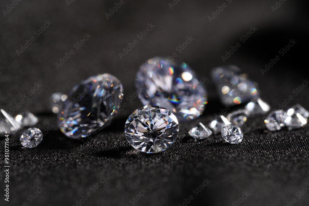 Many beautiful shiny diamonds on black fabric, closeup Many beautiful shiny diamonds on black fabric, closeup
