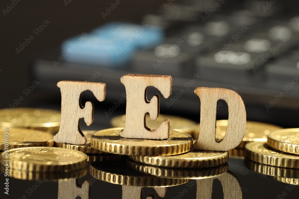 Letters Fed (Federal Reserve System) and coins on mirror table, closeup Letters Fed (Federal Reserve System) and coins on mirror table, closeup