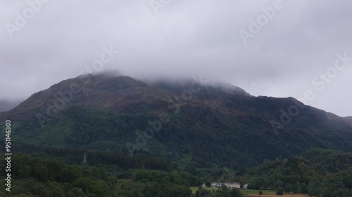 Aerial view of mountain in Scotland with very low clouds on rainy day photo