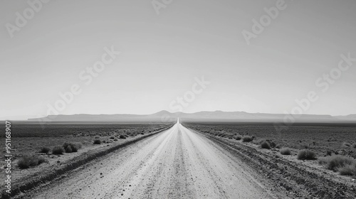 Desert road under a clear sky, minimalist, monochrome, high contrast, endless journey