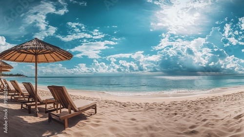 Panoramic view of a tropical beach featuring sea, sand, and sky, with romantic elements like chairs, umbrellas, and palm leaves, creating a luxurious travel destination atmosphere. photo