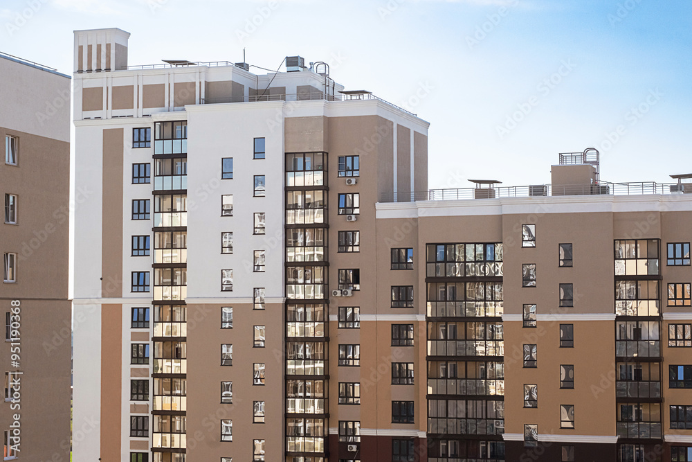Fototapeta premium Modern apartment buildings with multiple windows and balconies.