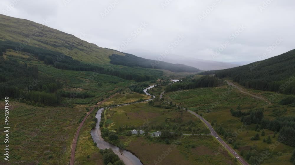Aerial view looking down valley in the Scottish highlands with river running through on cloudy day Aerial view looking down valley in the Scottish highlands with river running through on cloudy day