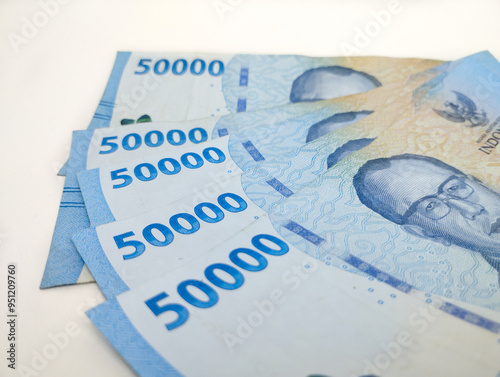 Close up Fifty thousand Indonesian banknotes (Rupiah). Cash payment concept. Indonesian rupiah currency (Rp. 50,000 Fifty Thousand Rupiah) on a white background