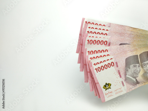 Close up One Hundred thousand Indonesian banknotes (Rupiah). Cash payment concept. Indonesian rupiah currency (Rp. 100,000 One Hundred Thousand Rupiah) on a white background
